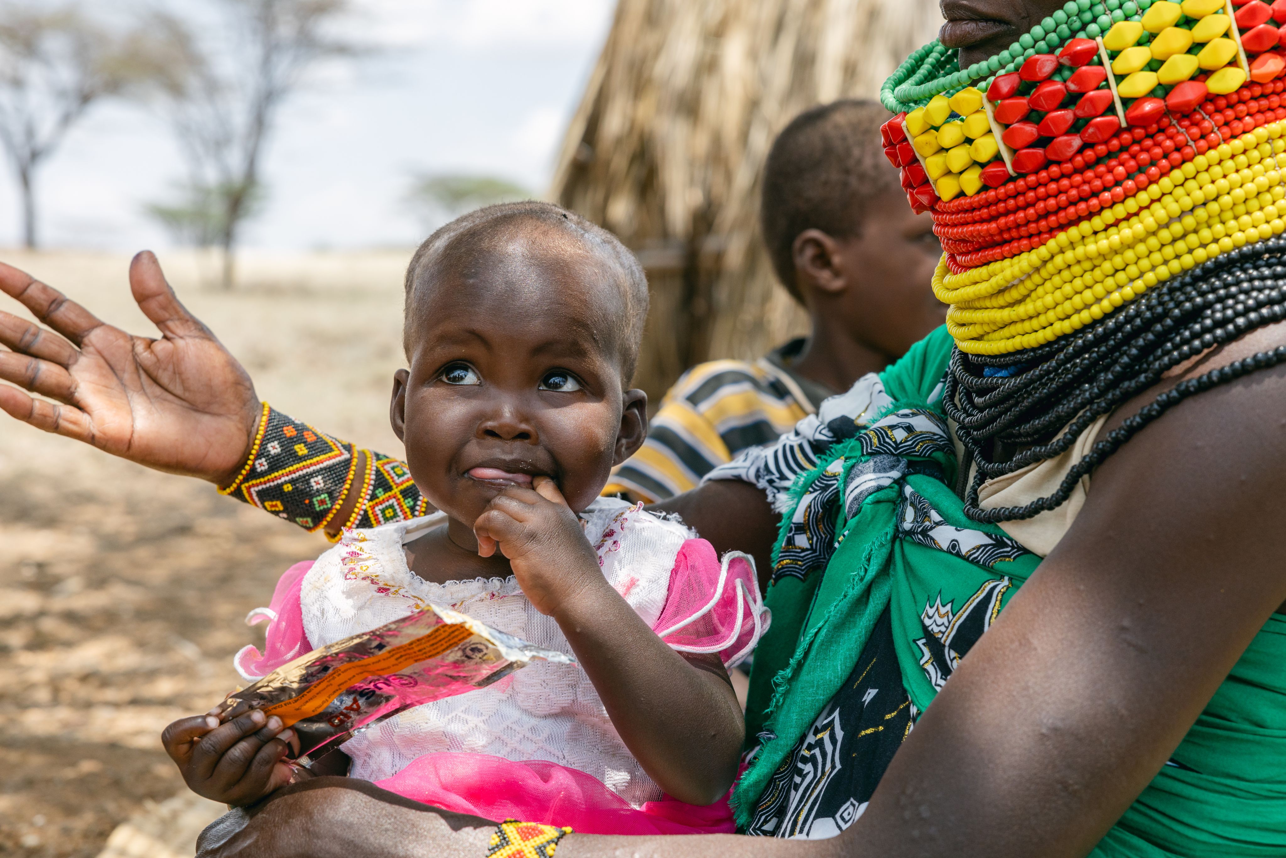 Ereng's mother feeds her fortified peanut paste provided by Charles