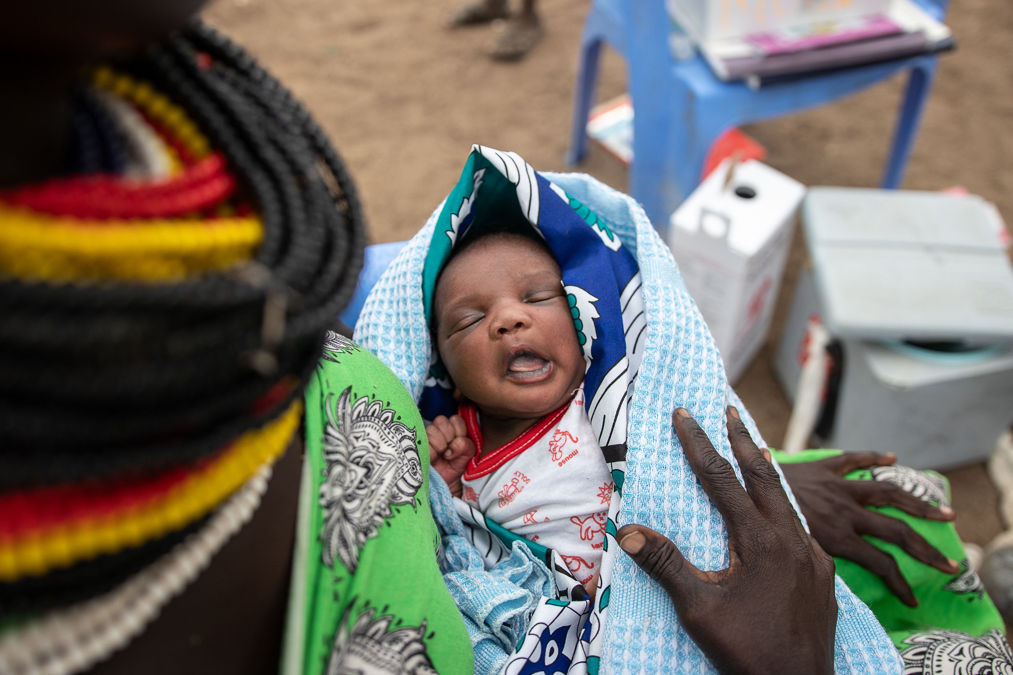 Lydia (28) holds her newborn baby Elimlim (2 weeks), Turkana, Kenya