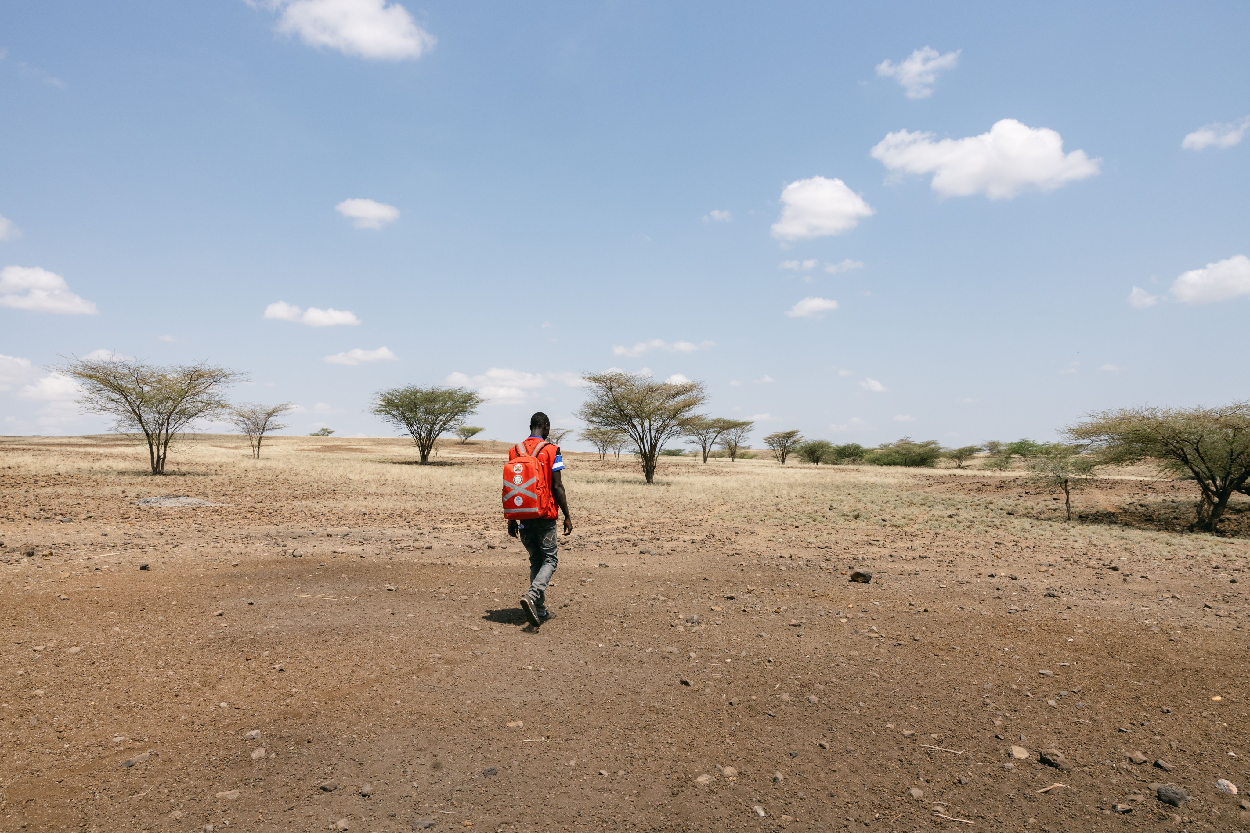 Charles walks for hours a day to reach remote villages.