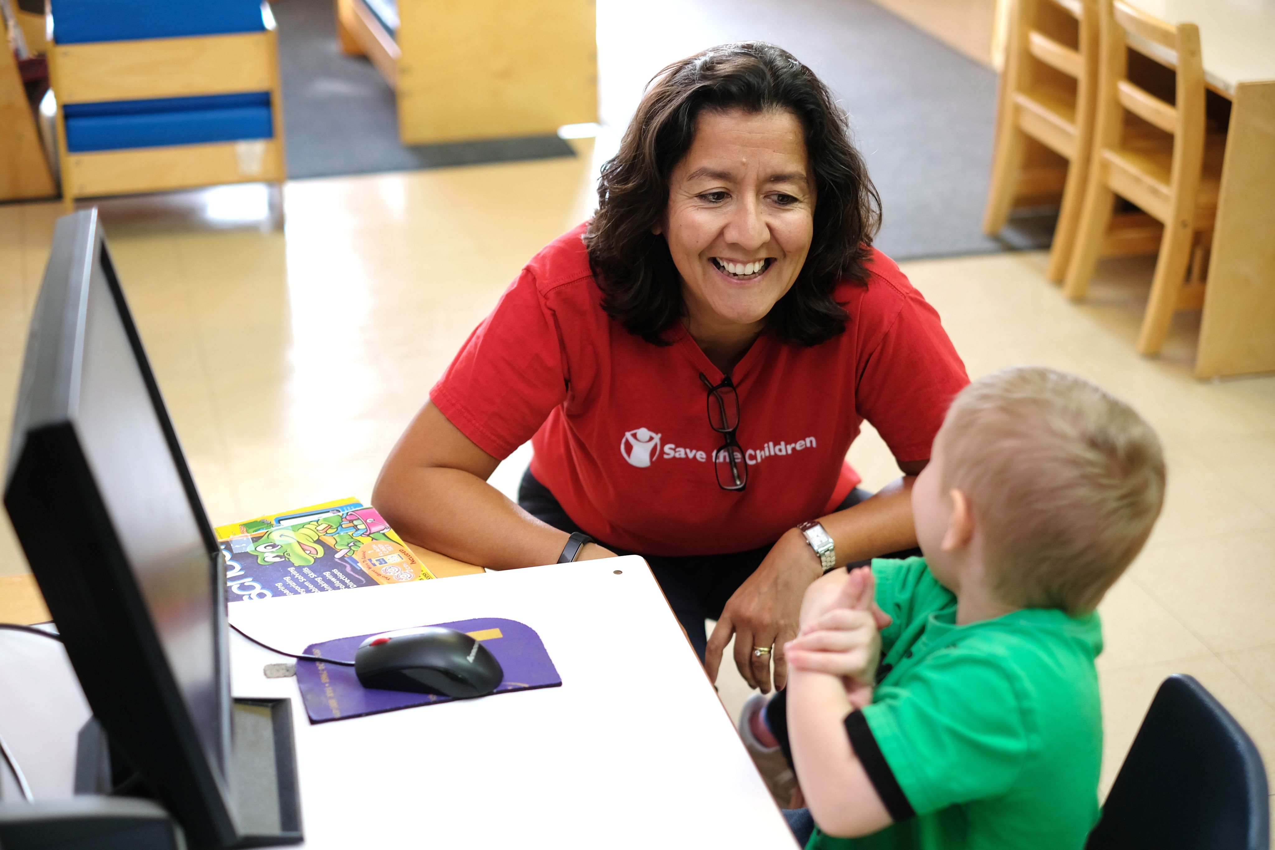 CEO Janti Soeripto visiting with a schoolchild