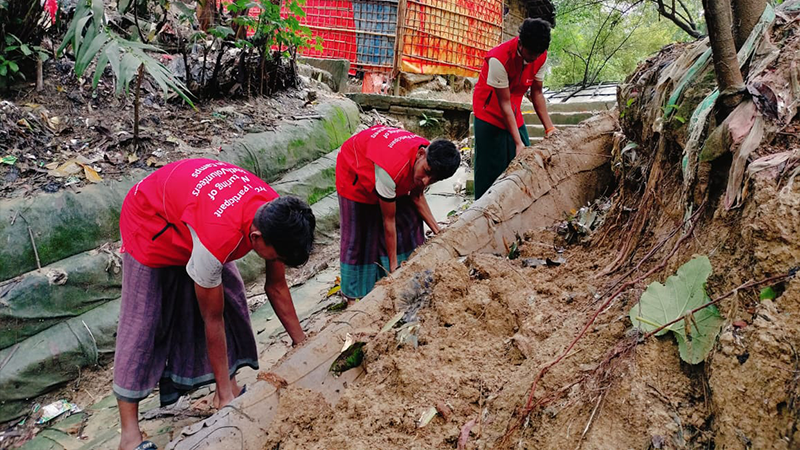 Three workers at a disaster scene