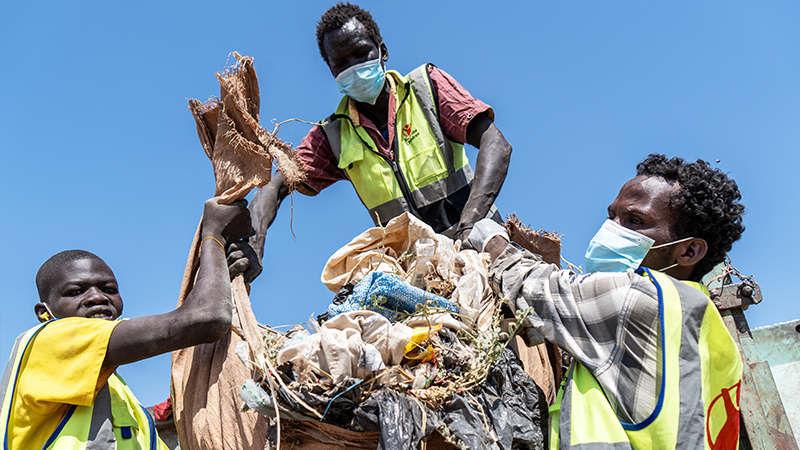 Three workers removing debris