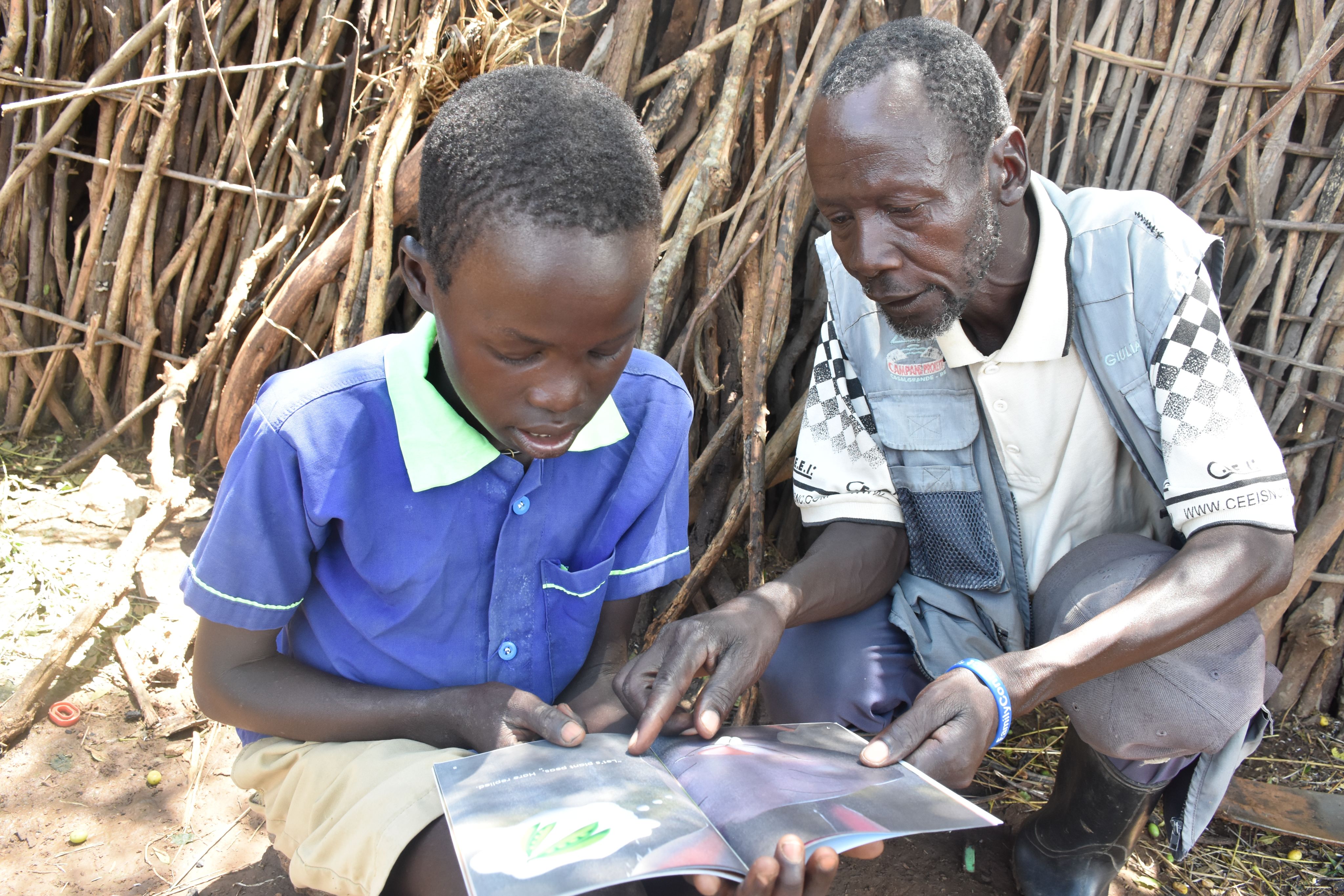 An aid worker worker teaching a young child remotely